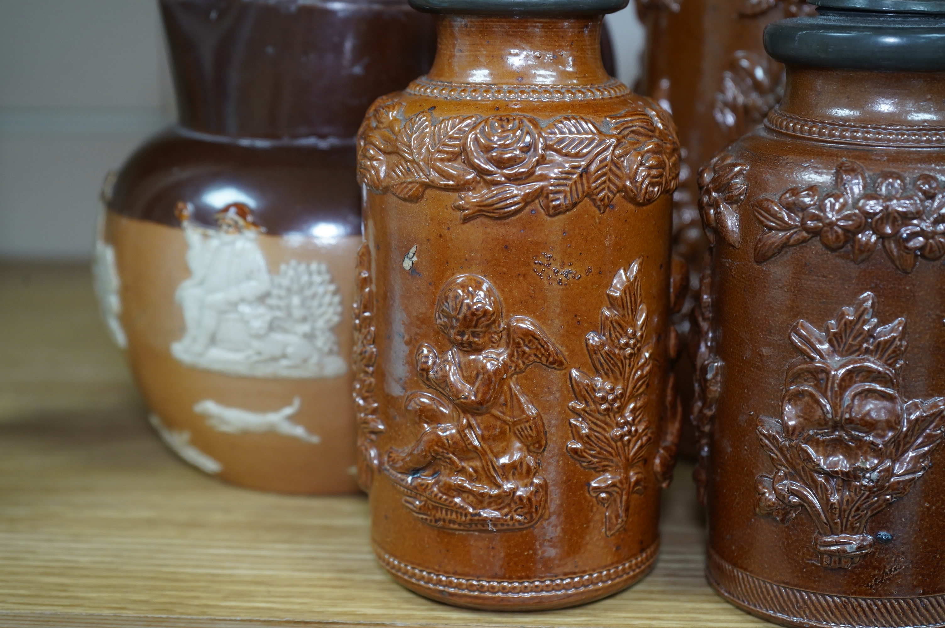 Four 19th century Derbyshire lead glazed stoneware jars and a stoneware jug and another, tallest 21cm (6). Condition - poor to fair